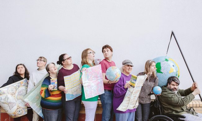 Photo of a group of people holding maps.